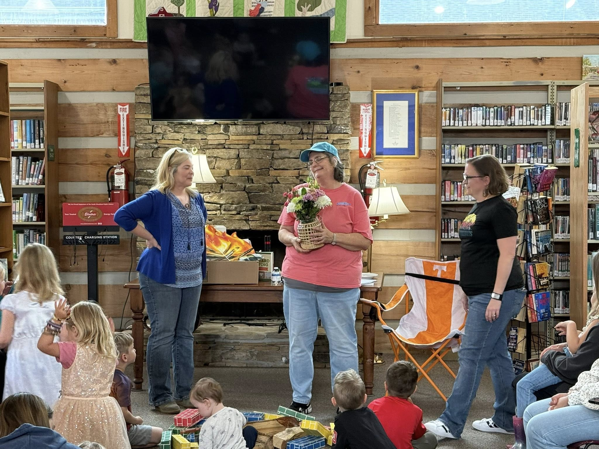 Library Director Jennifer Ensley (left) presented Miss Velvet (middle) with a bouquet of flowers following her last storytime on April 24. Miss Velvet has been the leader of Thursday morning storytimes at the South Cheatham Public Library since 2000. / South Cheatham County Public Library